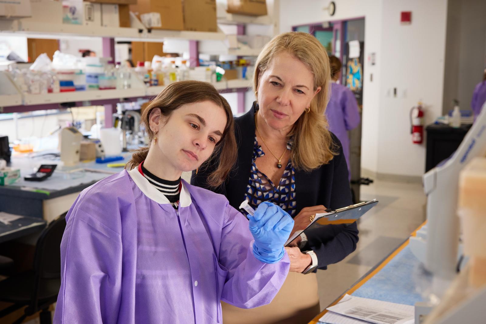 Catherine Bollard with a lab member